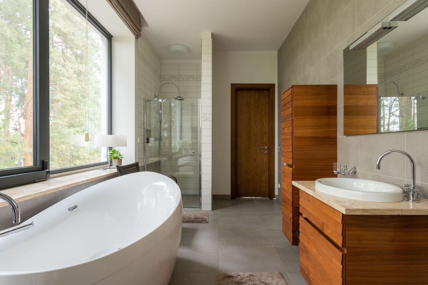 A bathroom with a freestanding bath, a timber vanity and a walk-in shower