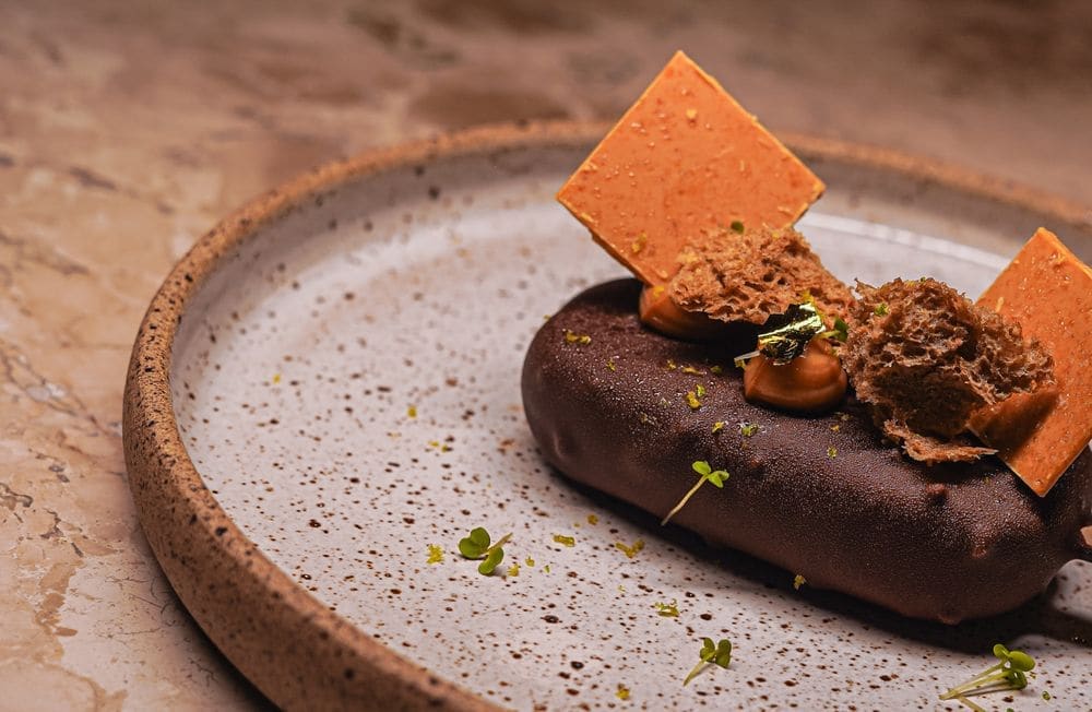 A dessert on a speckled ceramic plate