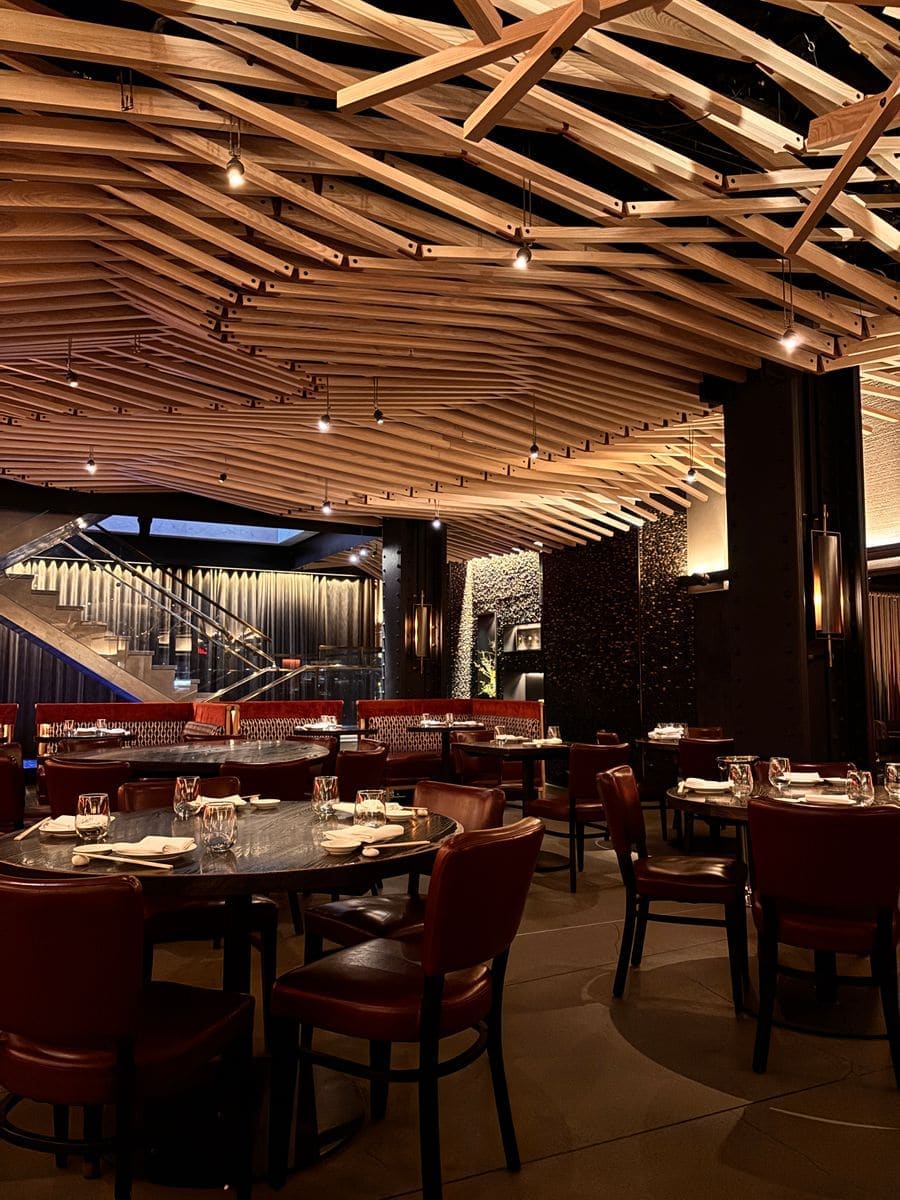 The dining room at night with low lights and set tables