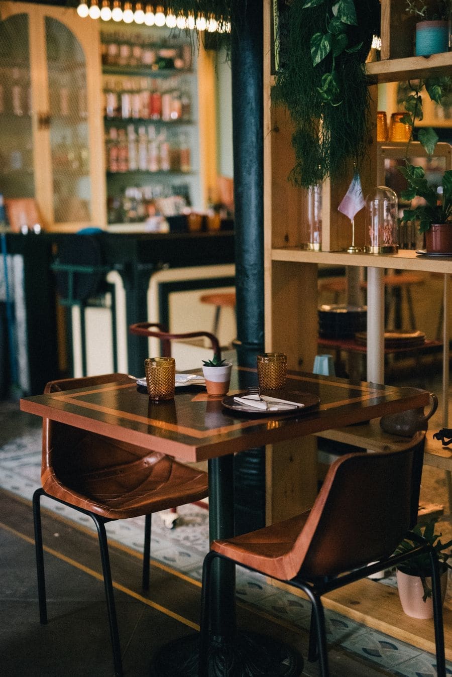 A table by the window with a small lamp