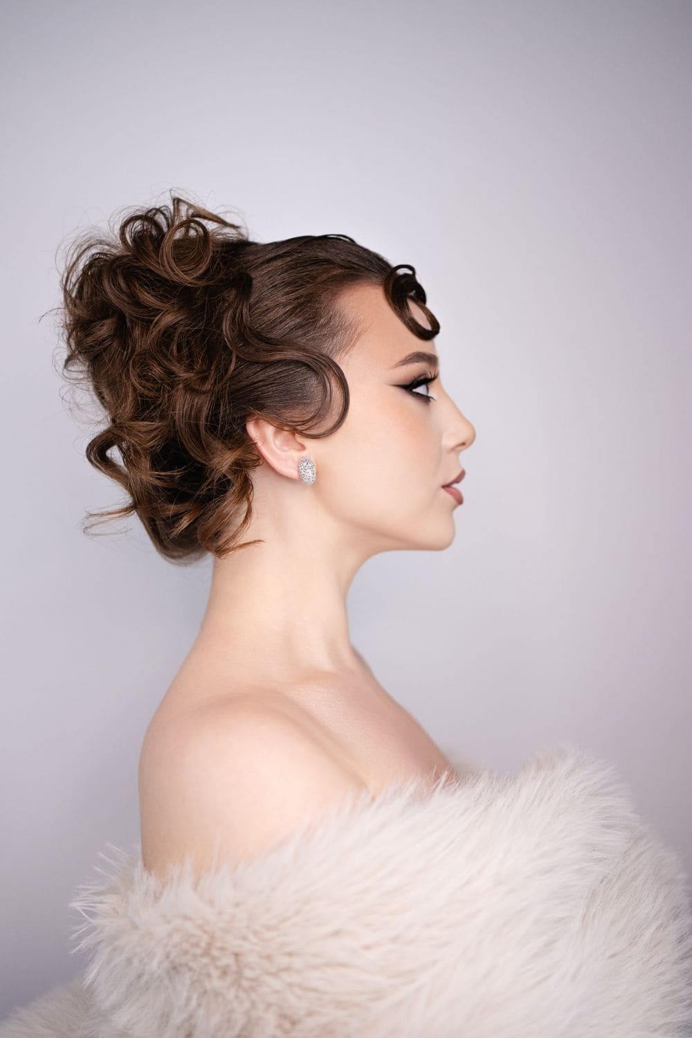 A low, sculpted updo seen from the side