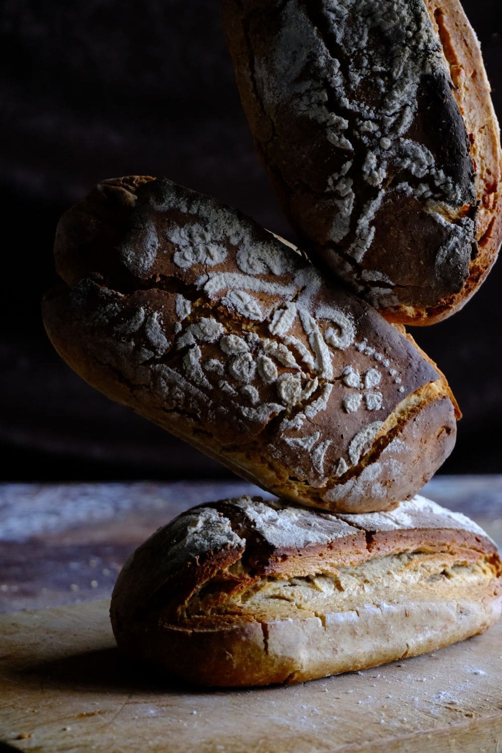 A sourdough loaf with a floured, patterned crust