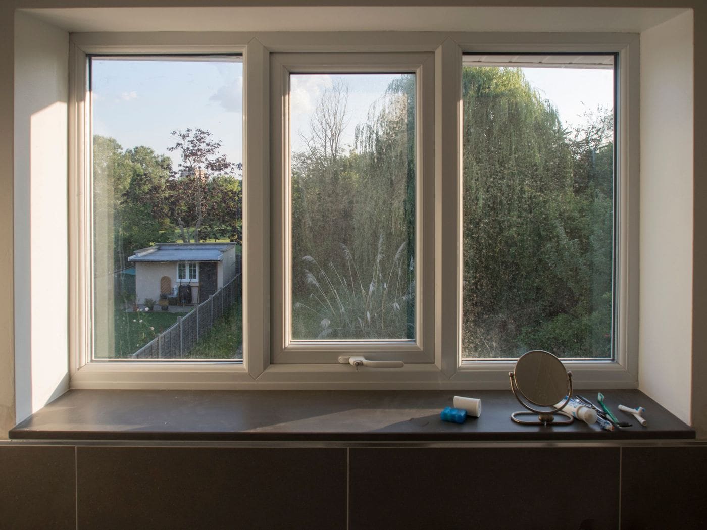 A deep window seat built under three timber-framed windows