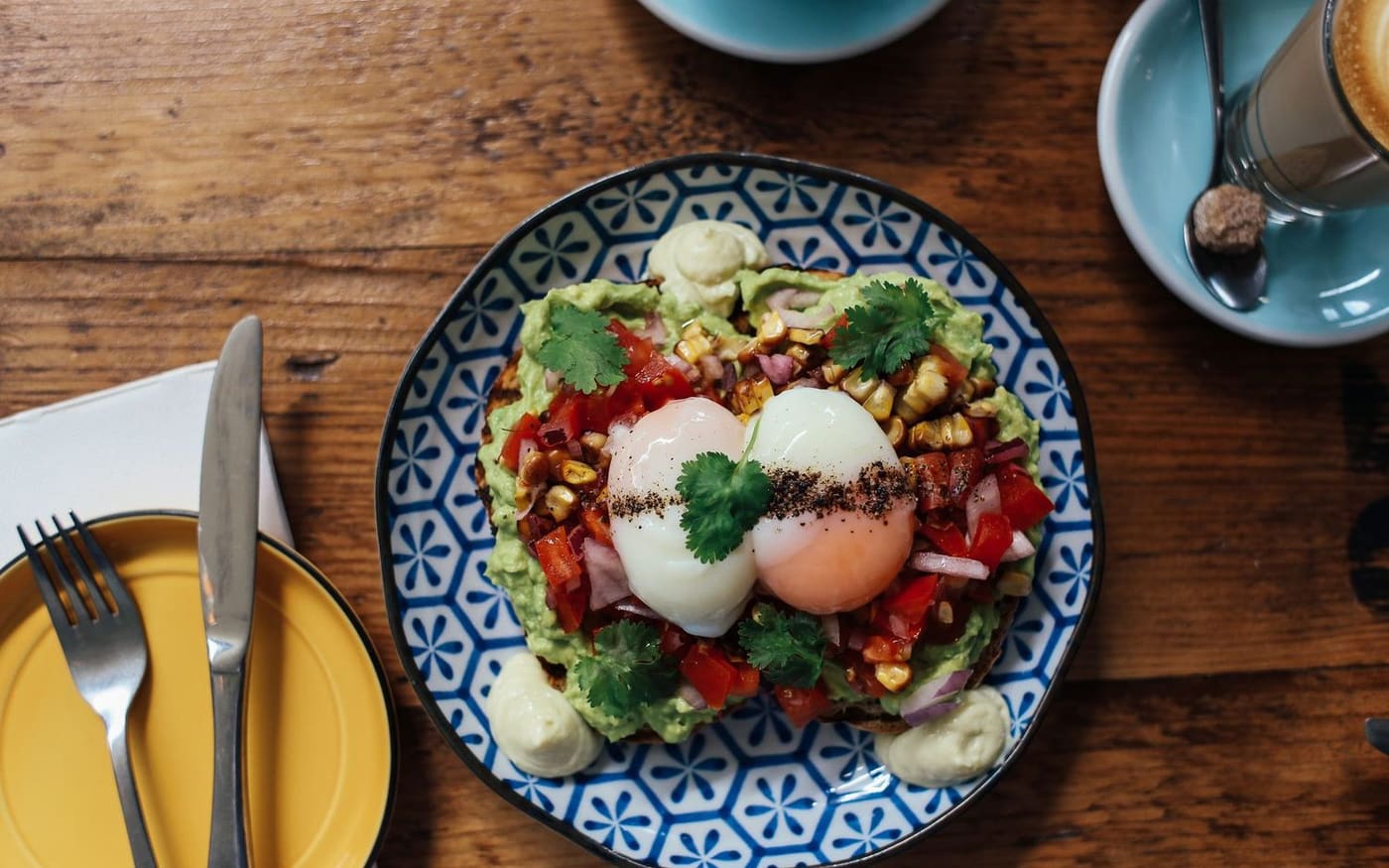 Poached eggs and salad on a patterned plate, seen from above
