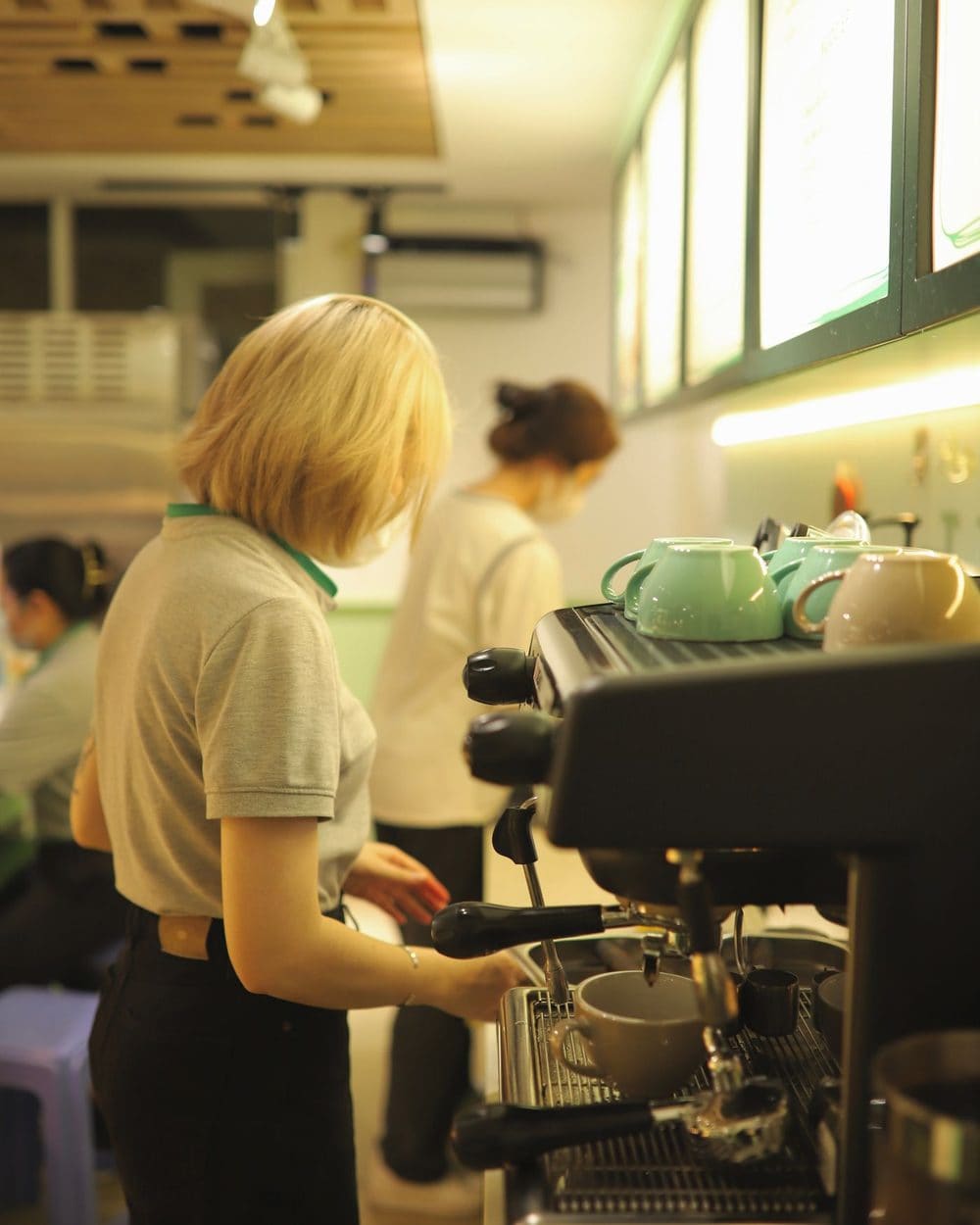 A barista pulling a shot at the espresso machine