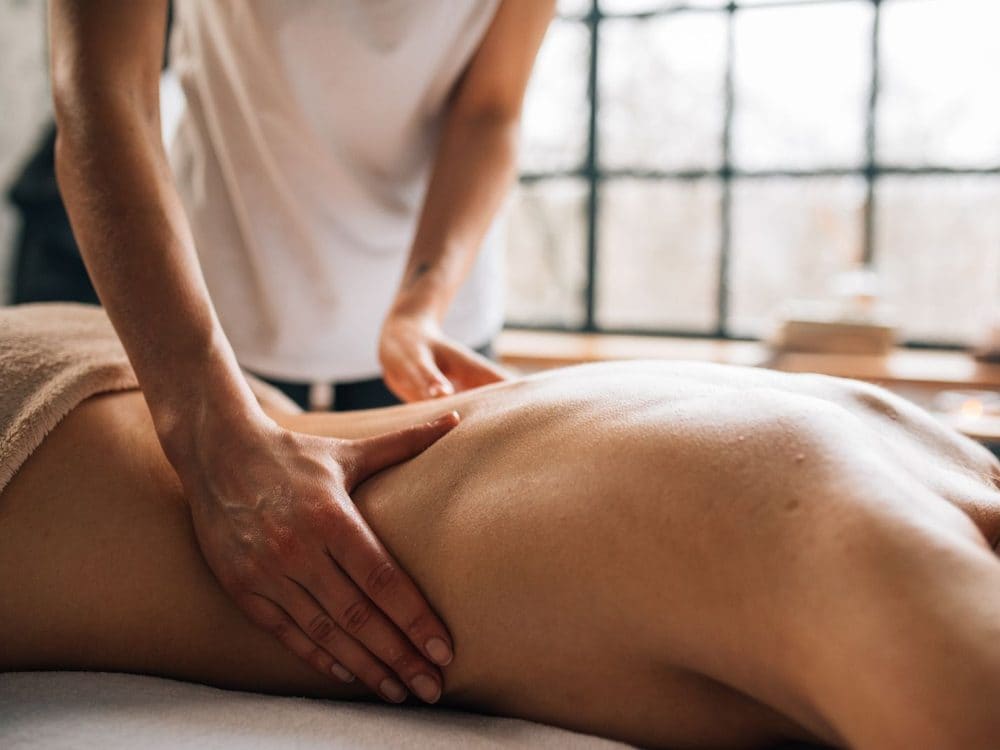 A massage therapist working on a client's shoulder