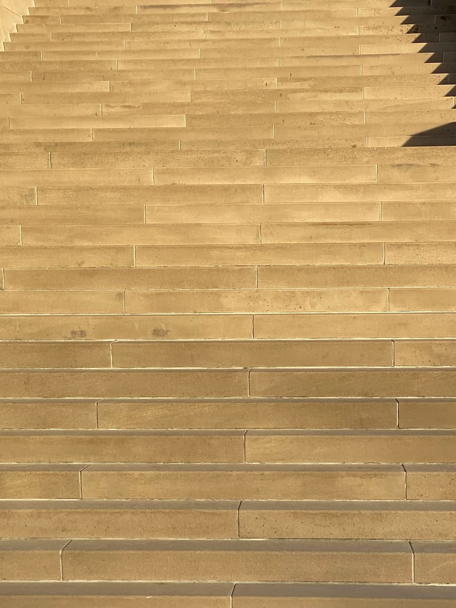 Rows of pale sandstone steps seen from above